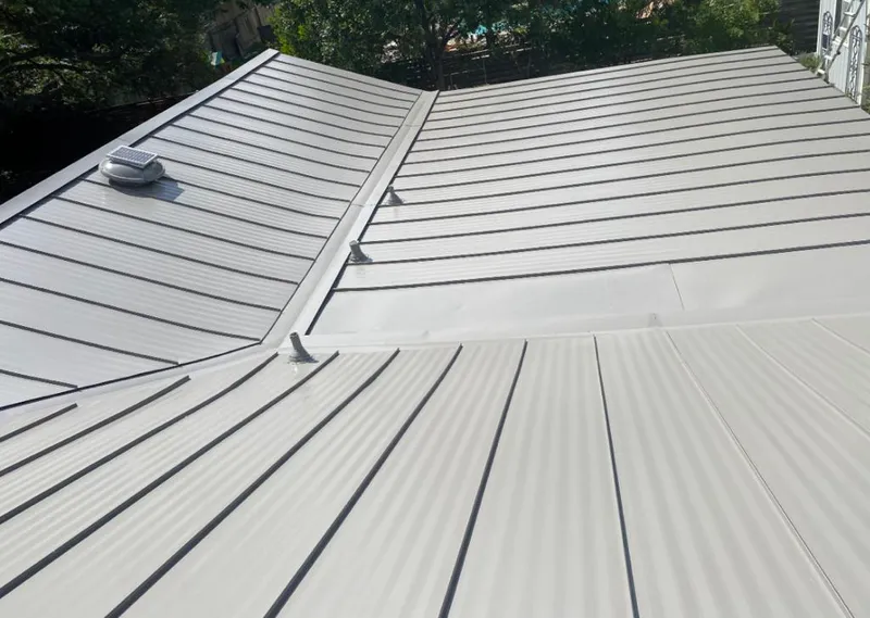 Solar attic fan installed on a metal roof for Roof Ventilation in Kosciusko